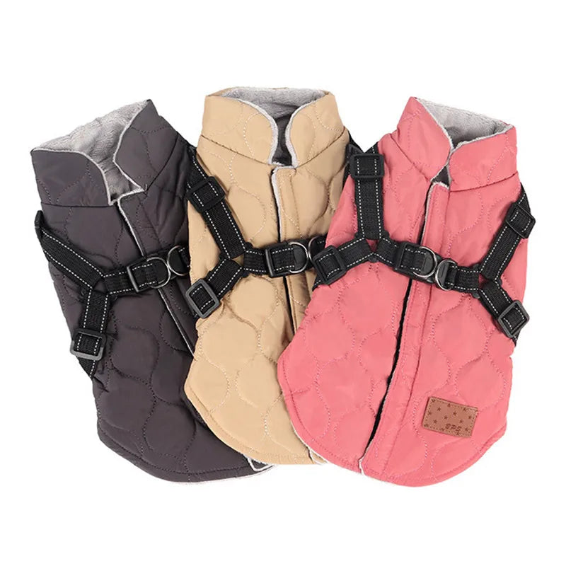 Three dog vests in gray, beige, and pink with harnesses on a white background
