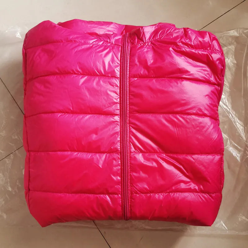 Pink puffer jacket on a tiled floor