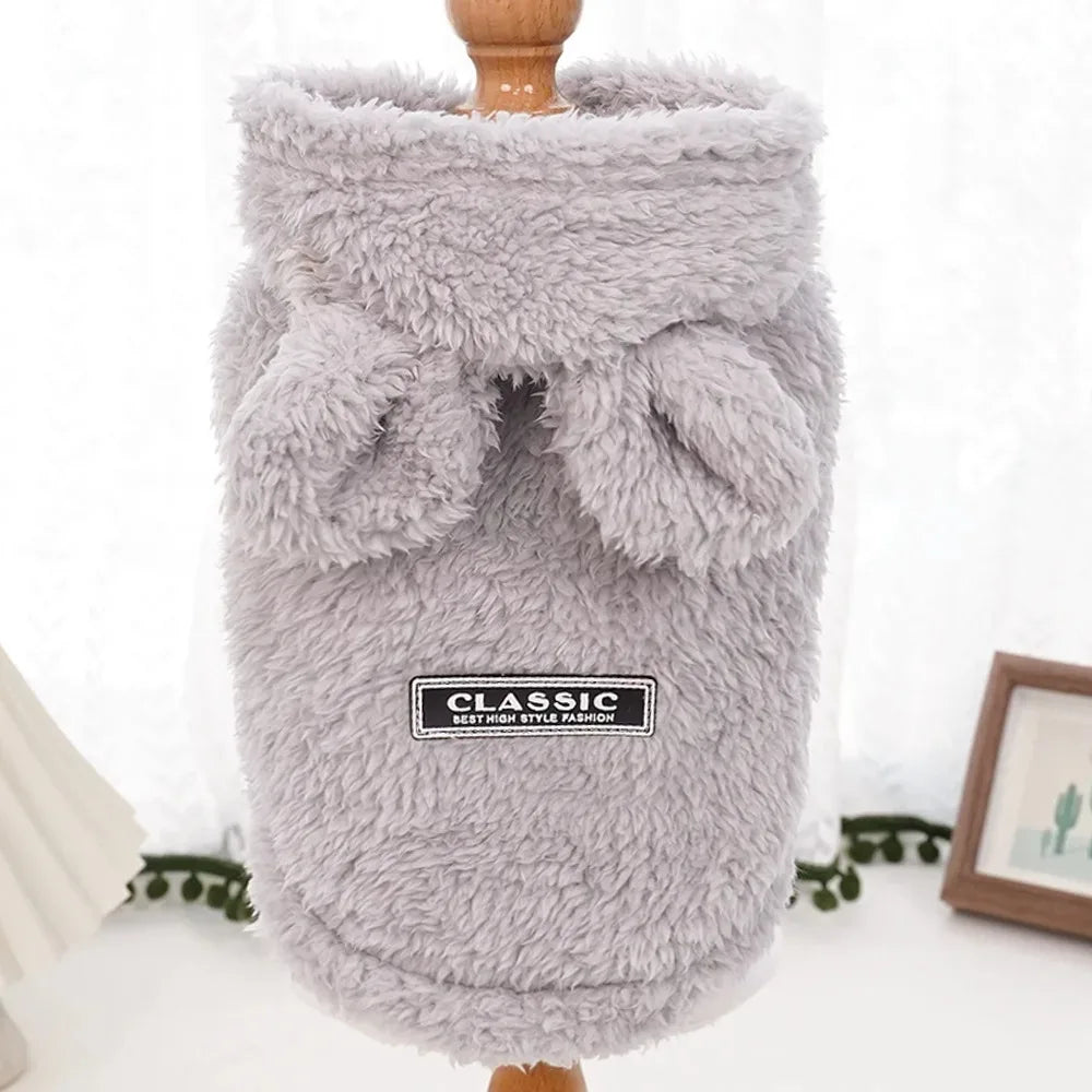 Fluffy gray dog coat with a label on a white background