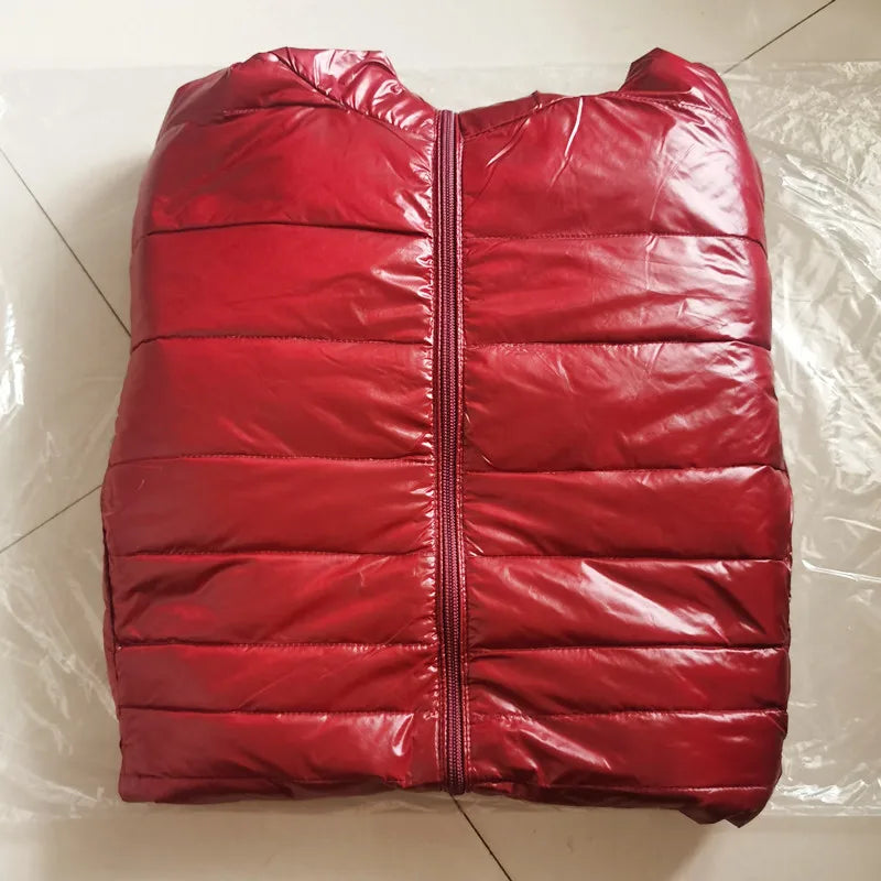 Red puffer vest on a white tiled floor