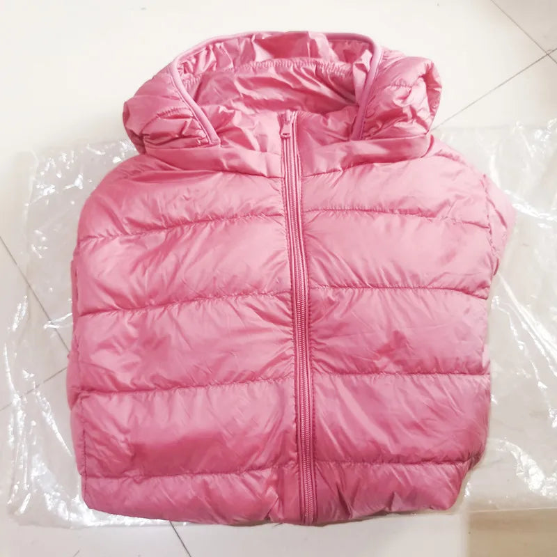 Pink puffer vest on a white tiled floor
