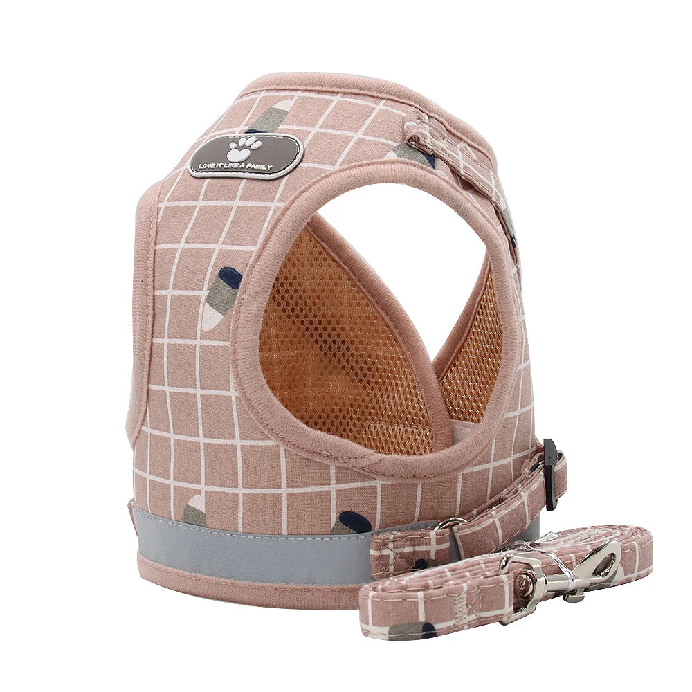 Pink plaid dog harness and leash set on a white background