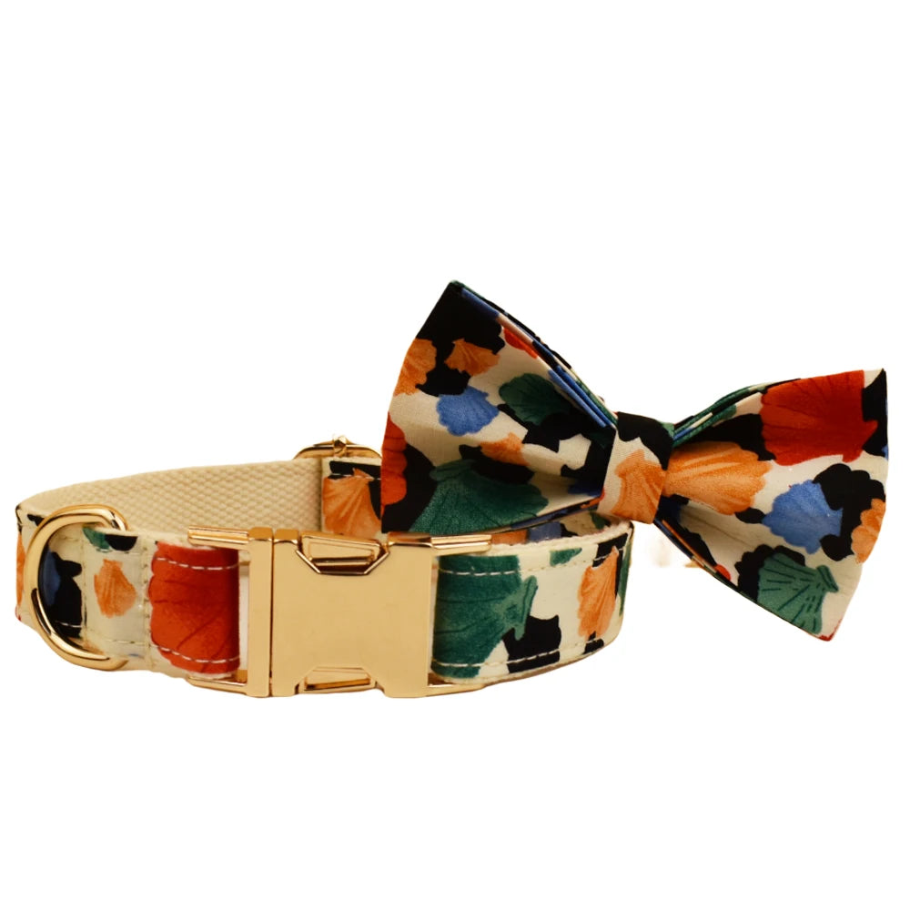 Dog collar with a colorful bow tie and gold buckle on a white background
