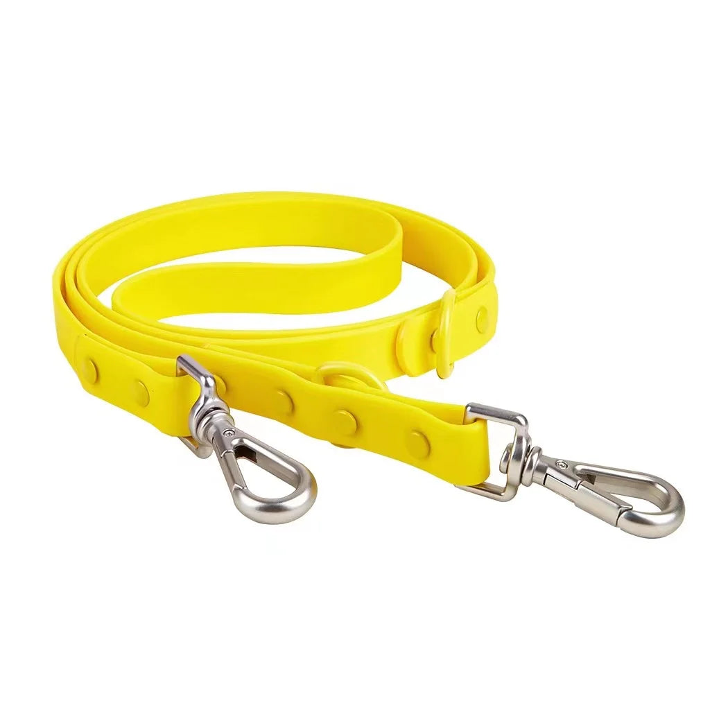 Yellow dog leash with metal clip on a white background