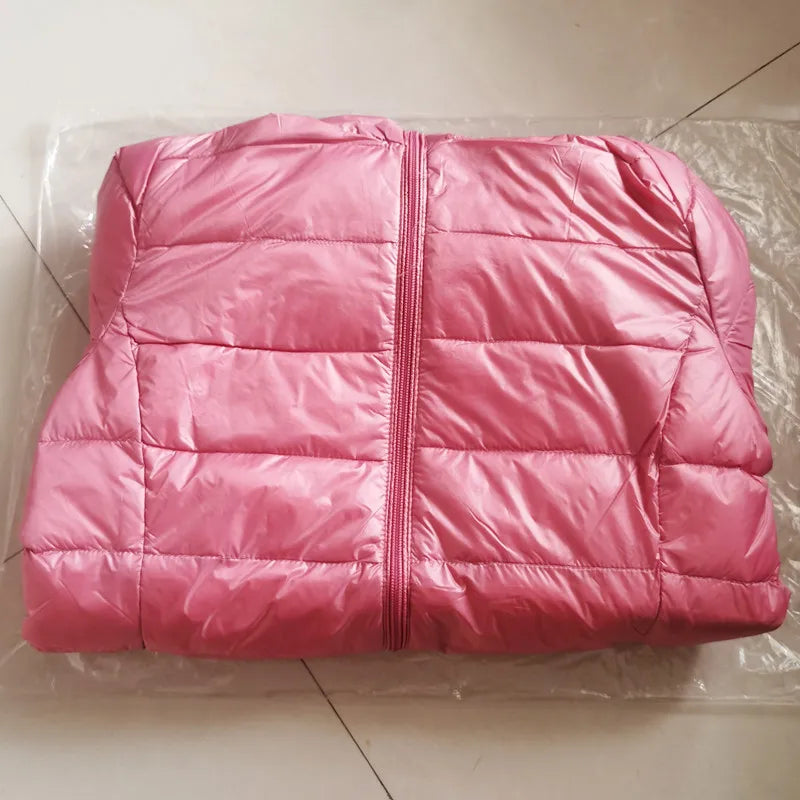 Pink puffer jacket on a tiled floor
