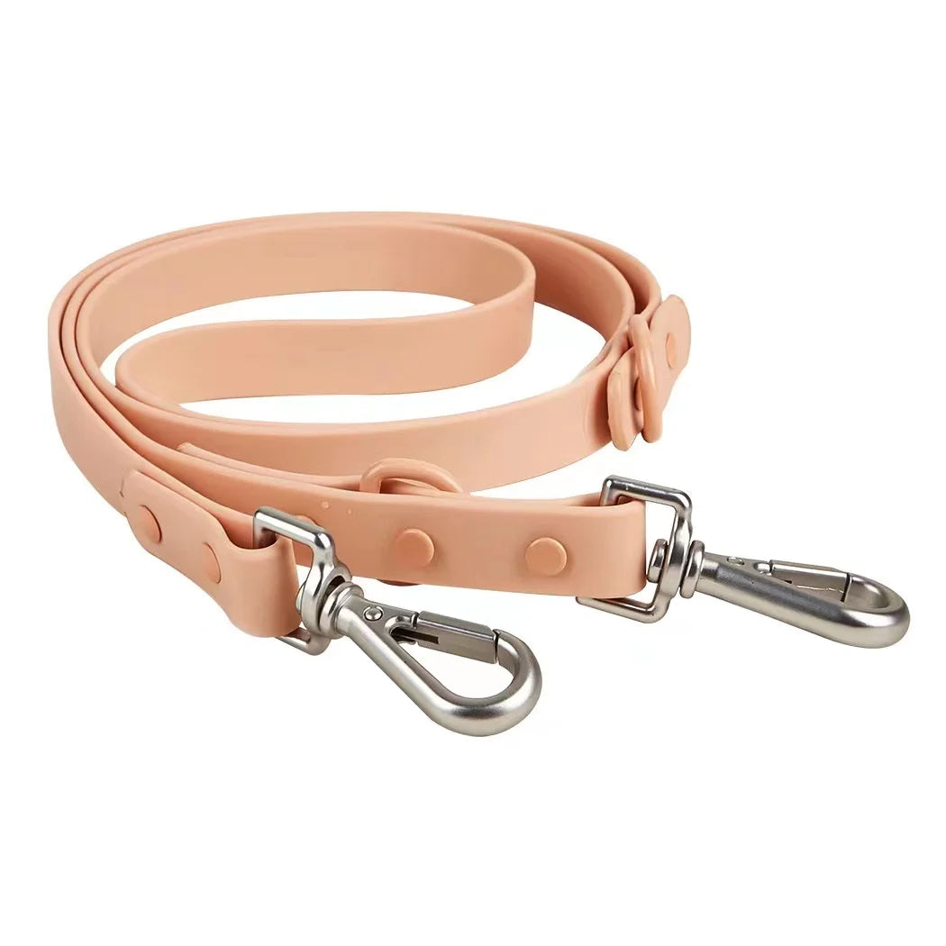 Beige dog leash with metal clip on a white background