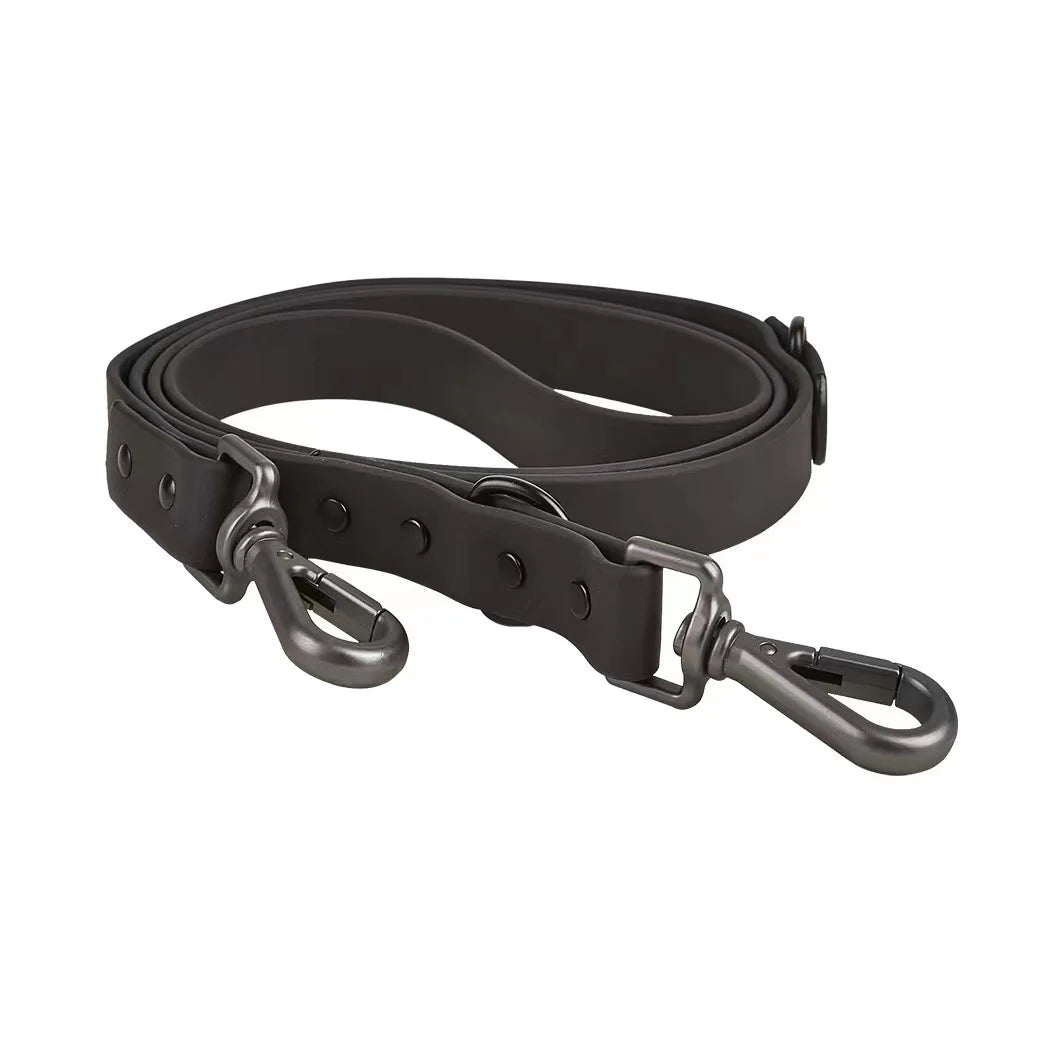 Black leather dog leash with metal clasp on a white background