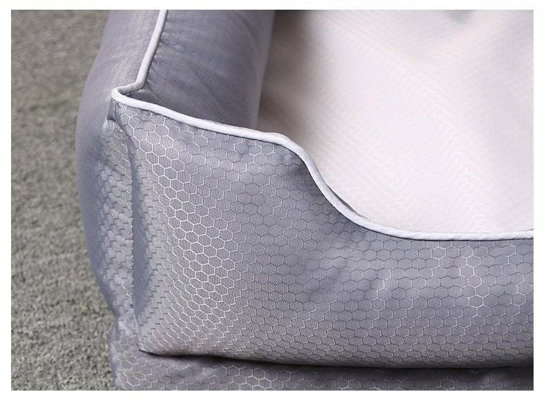 Gray pet bed with honeycomb pattern on a textured surface