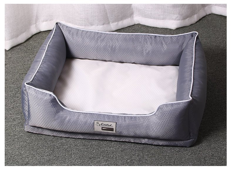Gray pet bed with a brand label on a gray surface