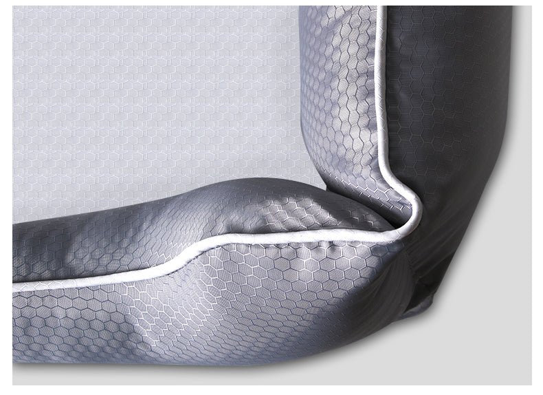 Close-up of a textured gray car seat cover with honeycomb pattern on a light gray background