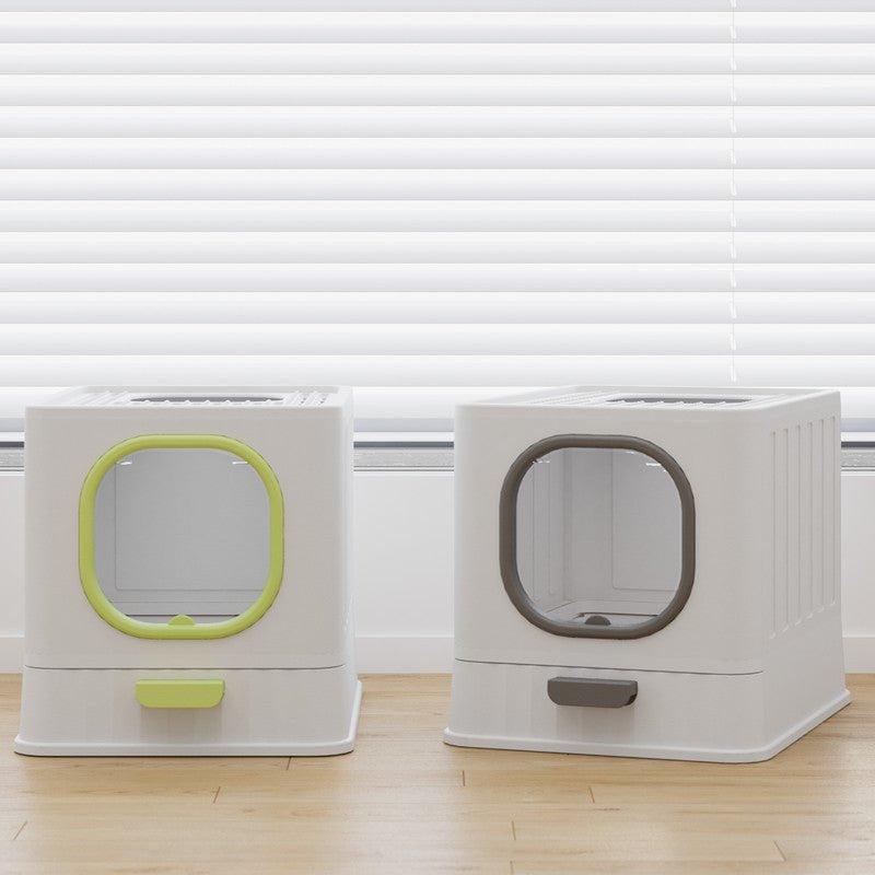 Two pet litter boxes with transparent lids on a wooden floor.